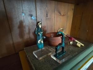 a miniature figurine of a woman on a sink at Galini Hotel Agios Ioannis Pelion in Agios Ioannis Pelio