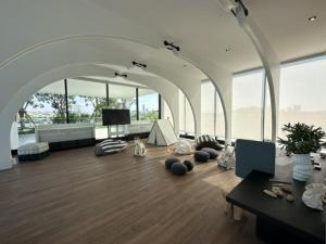 a living room with a large room with large windows at Luxury River View in Bangkok