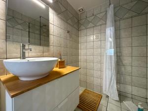 a bathroom with a white sink and a shower at TheasHomly in Kastanéa