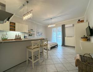 a kitchen with a table and chairs in a room at TheasHomly in Kastanéa