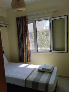 a bedroom with a bed and two windows at Calypso Two Bedroom Apartment in Kandia