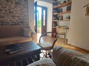 a living room with a couch and a table and chairs at Galini Hotel Agios Ioannis Pelion in Agios Ioannis Pelio