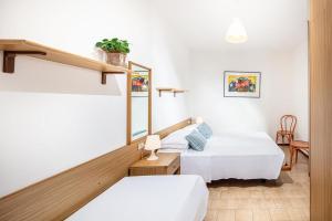 Appartamenti Valentina في بيبيوني: غرفة فندق بها سريران وطاولة