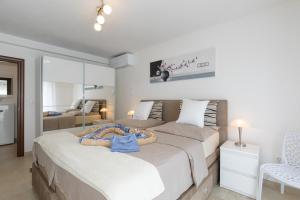 a bedroom with a large bed with a tray on it at House Zrile with jacuzzi in Baška