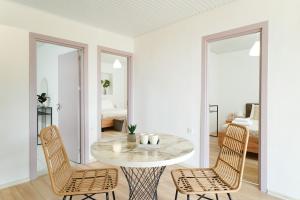 a white room with a table and two chairs at Marika's House in Kallirakhi