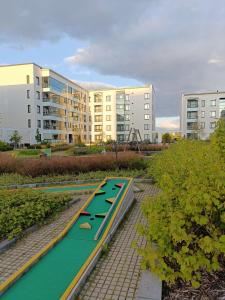 a row of paddle boards in a park with buildings at Toppilansalmi two bedroom apartment with a view in Oulu