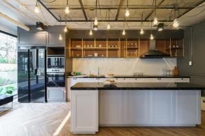 a kitchen with white cabinets and a large island at 沙吞Sathon-Charoen Nakhon精品公寓 in Bangkok