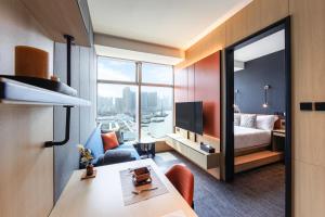 a hotel room with a bed and a room with a view at TOWNPLACE WEST KOWLOON in Hong Kong
