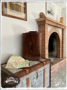 a brick fireplace with a barrel on top of it at Casa & Bottega Apartments in Rossano