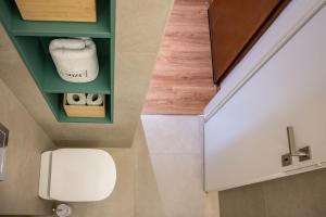 a bathroom with a white toilet in a room at MIZU APARTMA VAS LIPA OLIMJE in Podčetrtek