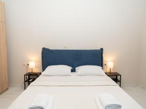 a bedroom with a large bed with two night stands at ALLAGIANNIS GROUP APARTMENTS in Markopoulo