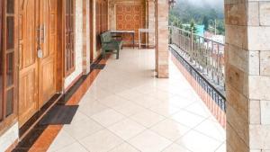 a balcony of a building with a table on it at Villa Al Barokah Syariah Family Mitra RedDoorz near Sarangan Lake in Sarangan