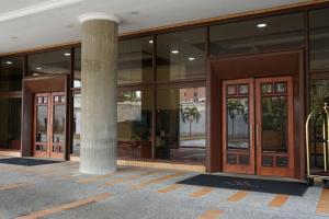 a large building with glass doors and a pillar at Marriott Venezuela Hotel Playa Grande in Playa Grande