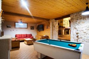 a living room with a pool table in a room at Maison de pierre in Saint-Gervais