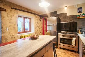 a kitchen with a counter top and a stove top oven at Maison de pierre in Saint-Gervais