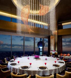 a large table in a room with a large chandelier at The Ritz-Carlton Shanghai, Pudong in Shanghai