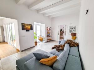 een woonkamer met een blauwe bank in een kamer bij Canostra Menorca Alaior in Alaior