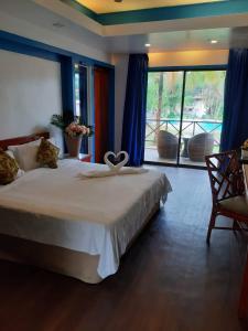 a bedroom with a bed with a heart decoration on it at PANORAMA RESORT LANGKAWI in Kuah