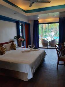 a bedroom with a bed and a large window at PANORAMA RESORT LANGKAWI in Kuah