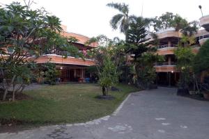 ein großes Gebäude mit Bäumen davor in der Unterkunft Hotel Bima in Klaten + 30 Fotos