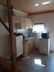 a small kitchen with a sink and a stove top oven at Domek letni in Pozezdrze