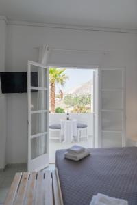 a bedroom with a bed and a view of a table at Sfiga villas in Perissa