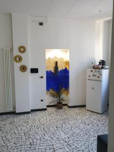 a room with two doors and a refrigerator at Angolo Relax Camere king in Rimini