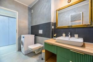 a bathroom with a sink and a toilet and a mirror at High Comfort Brasov in Braşov