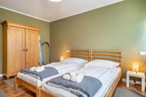 a bedroom with two beds with towels on them at Apfelbaum in Friedrichshafen