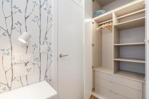 a walk in closet with blue and white wallpaper at LUXURY SILGAR in Sanxenxo +59 photos