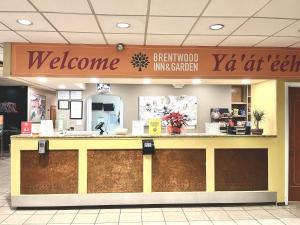 a store with a welcome sign above a counter at Brentwood Inn & Garden in Farmington