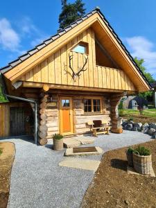 a log cabin with a clock on the roof at Blockhaus PanHütte in Braunlage