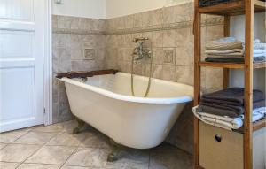 a white bath tub in a bathroom with towels at Awesome Home In Nysted With Wifi in Nysted +18 photos