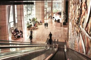 a group of people walking down an escalator in a building at The Ritz-Carlton Shanghai, Pudong in Shanghai