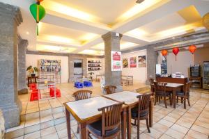 a restaurant with tables and chairs in a room at Puri Mesari Hotel in Sanur