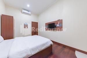 Ein Bett oder Betten in einem Zimmer der Unterkunft Maleo Residence Bandung Mitra RedDoorz