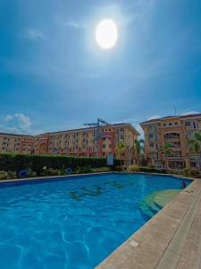 a large blue swimming pool in front of buildings at Arezzo Place Davao Condominium in Davao City