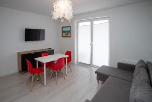 Televízia a/alebo spoločenská miestnosť v ubytovaní Stilo Hotel