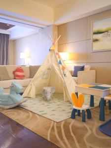 a room with a play room with a tent and toys at The Imperial Mansion, Beijing - Marriott Executive Apartments in Beijing