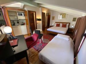 a hotel room with a bedroom with a bed and a desk at EGO' Hotel in Ferrara