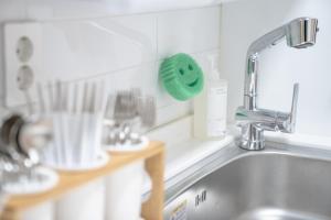 a kitchen counter with a sink and a green sponge at Greenery SEOUL in Seoul +54 photos