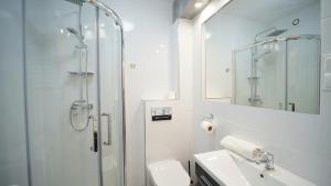 a bathroom with a shower and a toilet and a sink at Apartamenty EverySky - Nad Łomnicą 14A-B in Karpacz +40 photos