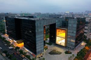 an overhead view of a tall building with lights on at SSAW Boutique Hotel Yingyang in Hangzhou