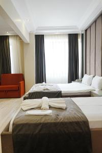 a hotel room with two beds with towels on them at Reyyan Hotel in Istanbul