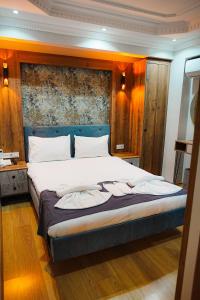 a bedroom with a large bed with a blue headboard at Reyyan Hotel in Istanbul