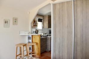 a small kitchen with a small island in a room at Provence.bienvenue chez nous in Rognes