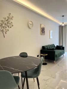 a living room with a table and a couch at Msida Marina Apartments in Msida