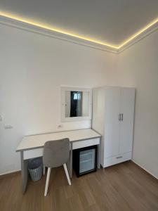 a white desk with a chair in a room at Vila Melina in Ksamil