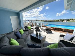 a living room with a large couch and a pool at Blue Haven in Jolly Harbour