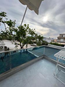 a swimming pool on the roof of a building at Hotel Vila Melina in Ksamil